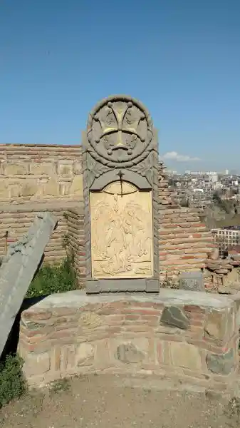Stone bas-relief of the cross and saint, solar cross